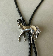 Load image into Gallery viewer, Vintage Sterling Silver Walking Horse Relief Black Leather Bolo Tie
