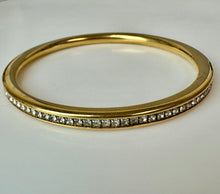 Load image into Gallery viewer, Goldtone Channel Set Cubic Zirconia Rounded Bangle Bracelet (8" Inside Circumference)
